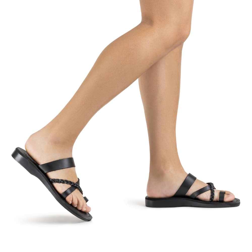 Model wearing Sophia in Black, handmade leather sandals with toe loop and cross straps