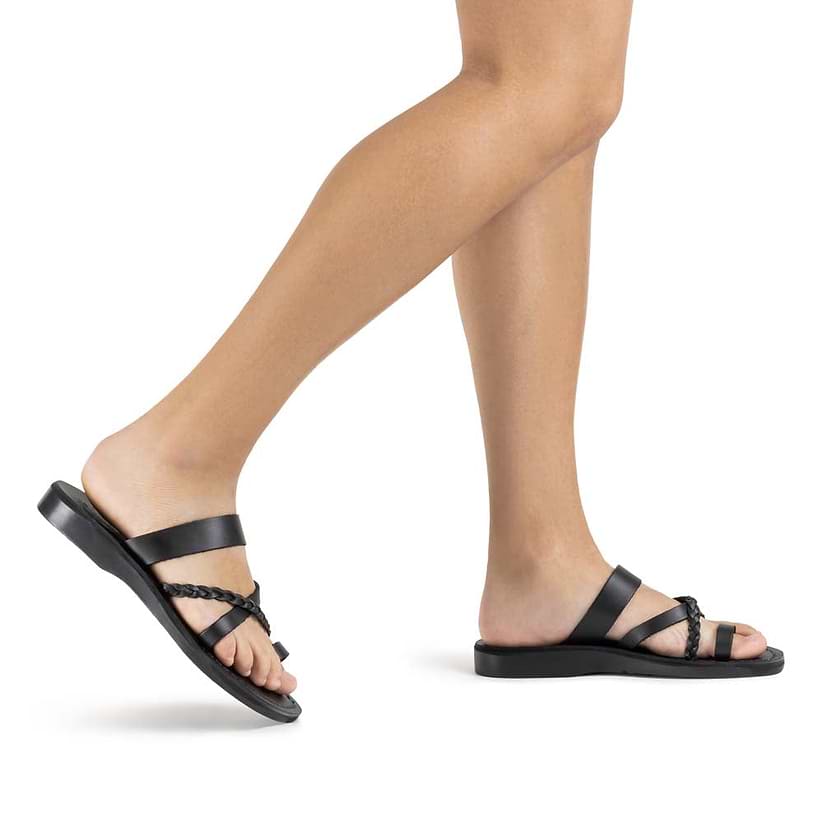 Model wearing Sophia in Black, handmade leather sandals with toe loop and cross straps