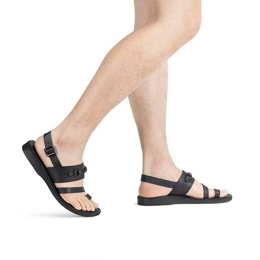 Model wearing Eliphaz black, handmade leather sandals with back strap and toe loop