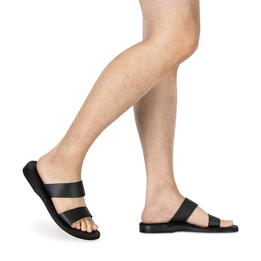 Model wearing Aviv black, handmade leather slide sandals