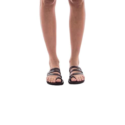 Model wearing Nora brown, handmade leather slide sandals with toe loop 