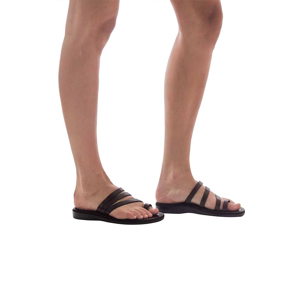 Model wearing Nora brown, handmade leather slide sandals with toe loop