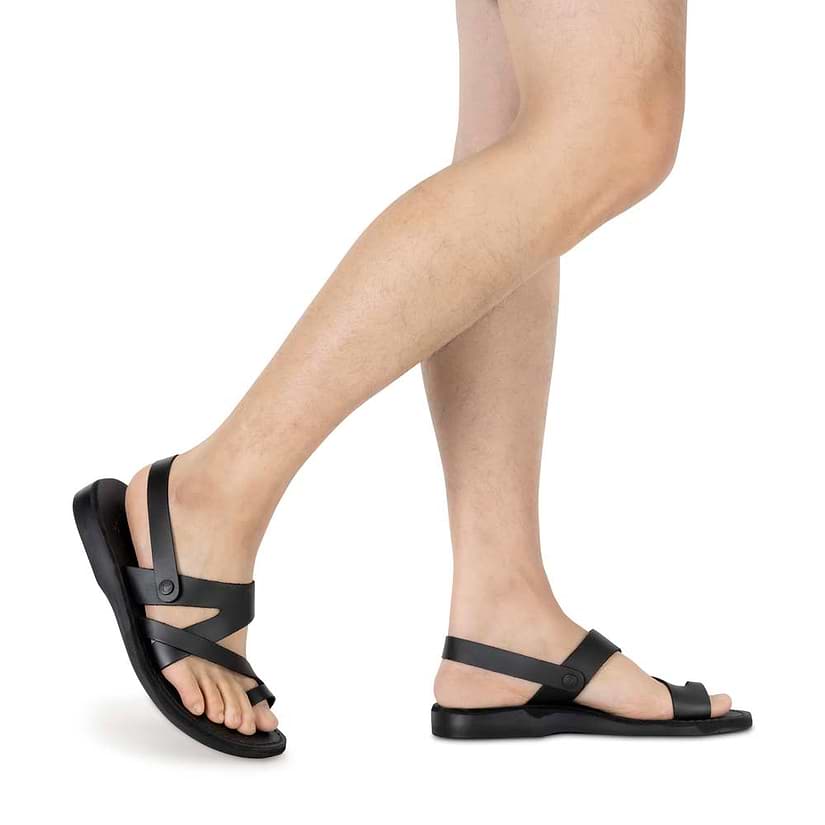 Model wearing Benjamin black, handmade leather sandals with back strap and toe loop