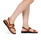 Model wearing Benjamin honey, handmade leather sandals with back strap and toe loop