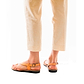 Model wearing Mia Tan, handmade leather buckle sandals with toe loop