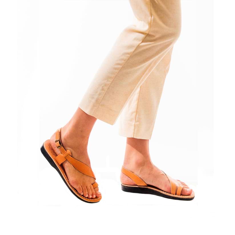 Model wearing Mia Tan, handmade leather buckle sandals with toe loop