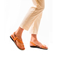 Model wearing Mia Tan, handmade leather buckle sandals with toe loop