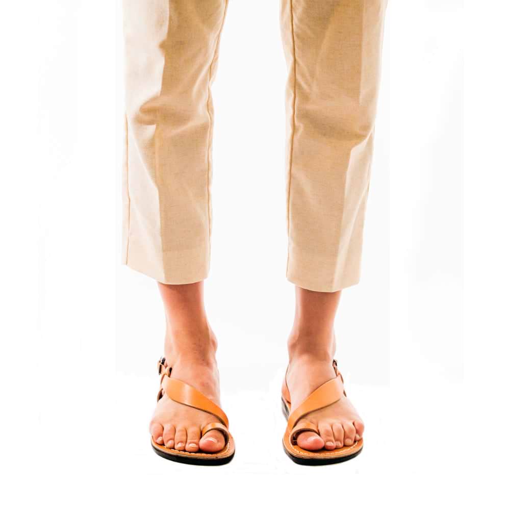 Model wearing Mia Tan, handmade leather buckle sandals with toe loop