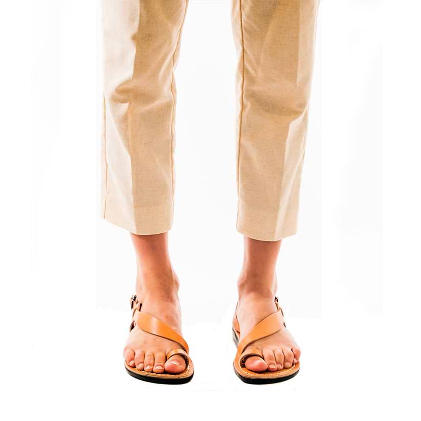 Model wearing Mia Tan, handmade leather buckle sandals with toe loop