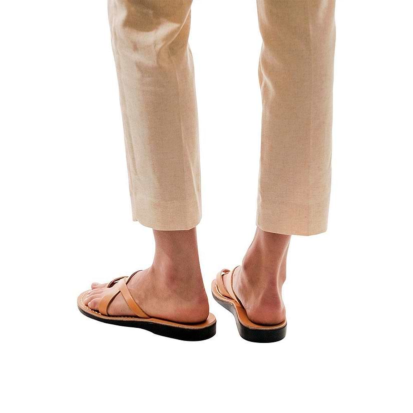 Model wearing Abigail tan, handmade leather slide sandals with toe loop