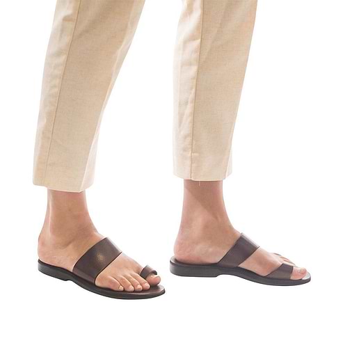 Model wearing Abra brown, handmade leather slide sandals with toe loop 