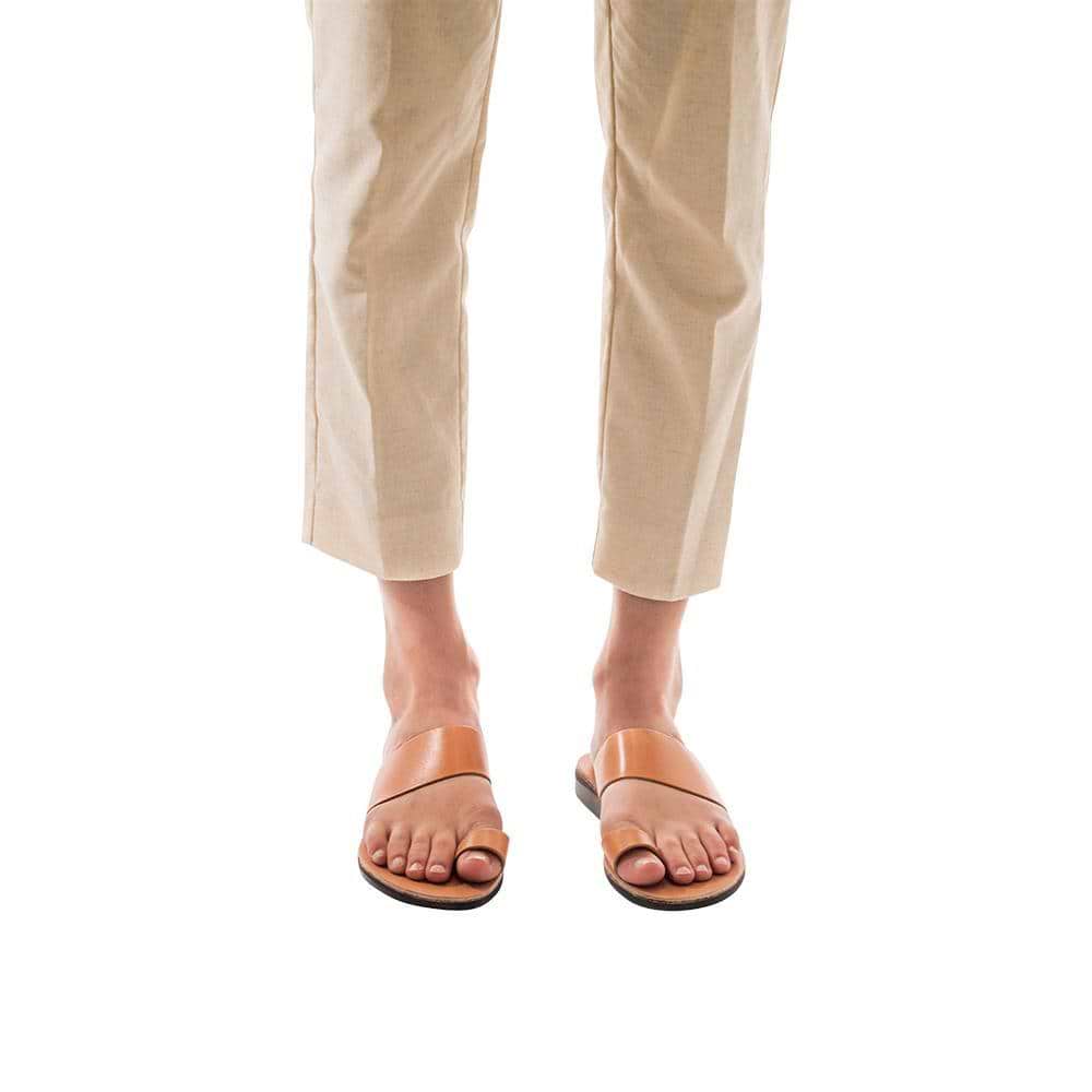 Model wearing Abra tan, handmade leather slide sandals with toe loop 