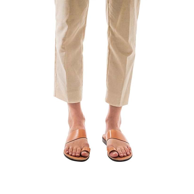 Model wearing Abra tan, handmade leather slide sandals with toe loop 