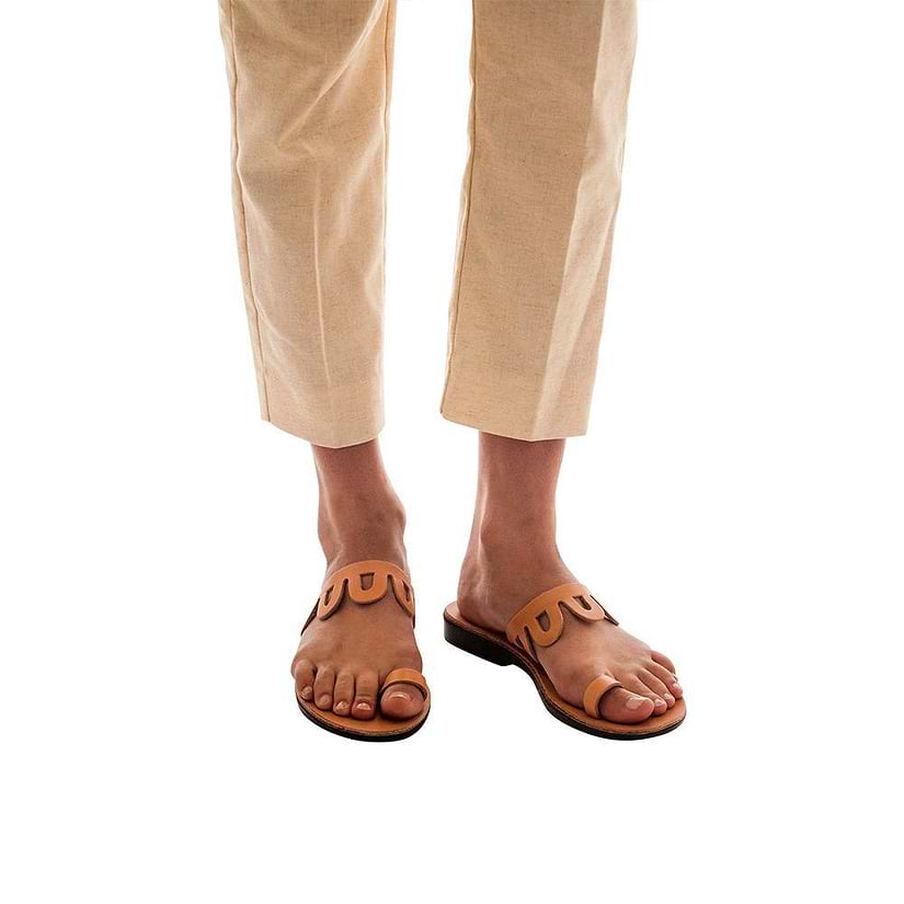 Model wearing Aja tan, handmade leather slide sandals with toe loop 