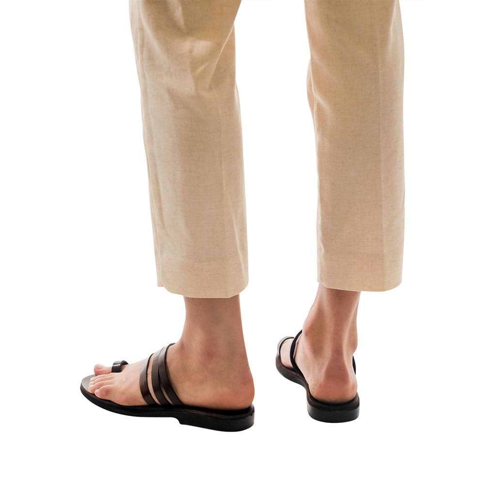 Model wearing Angela brown, handmade leather slide sandals with toe loop 