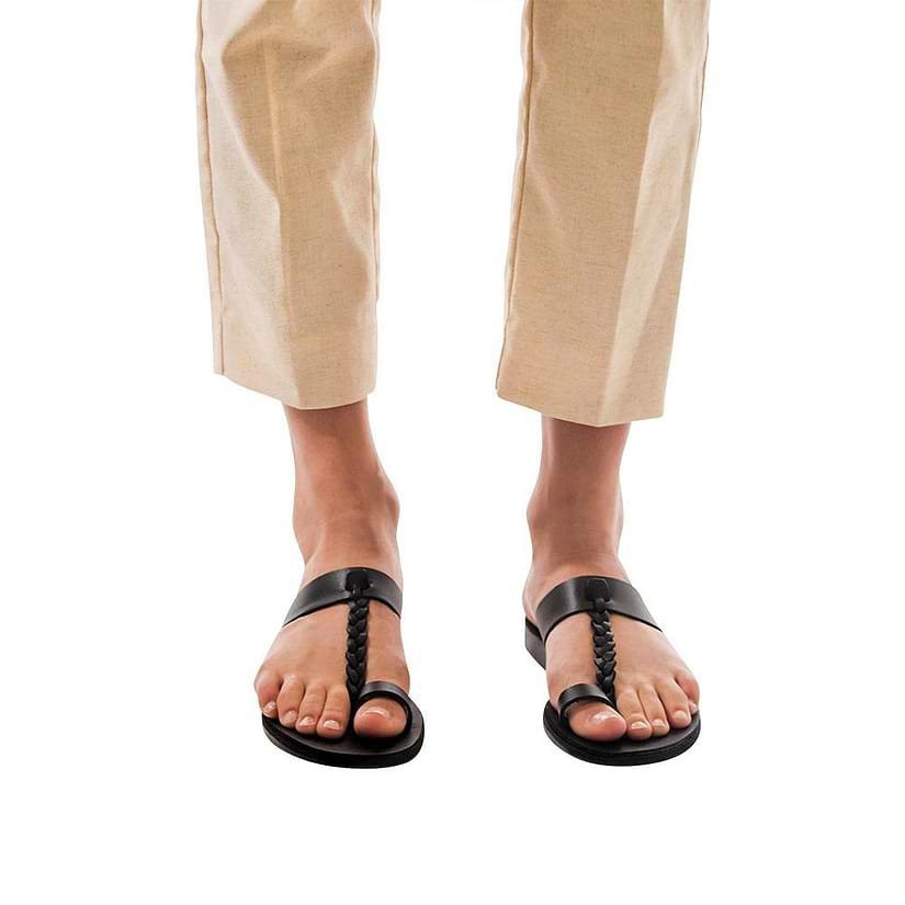 Model wearing Ara black, handmade leather slide sandals with toe loop 