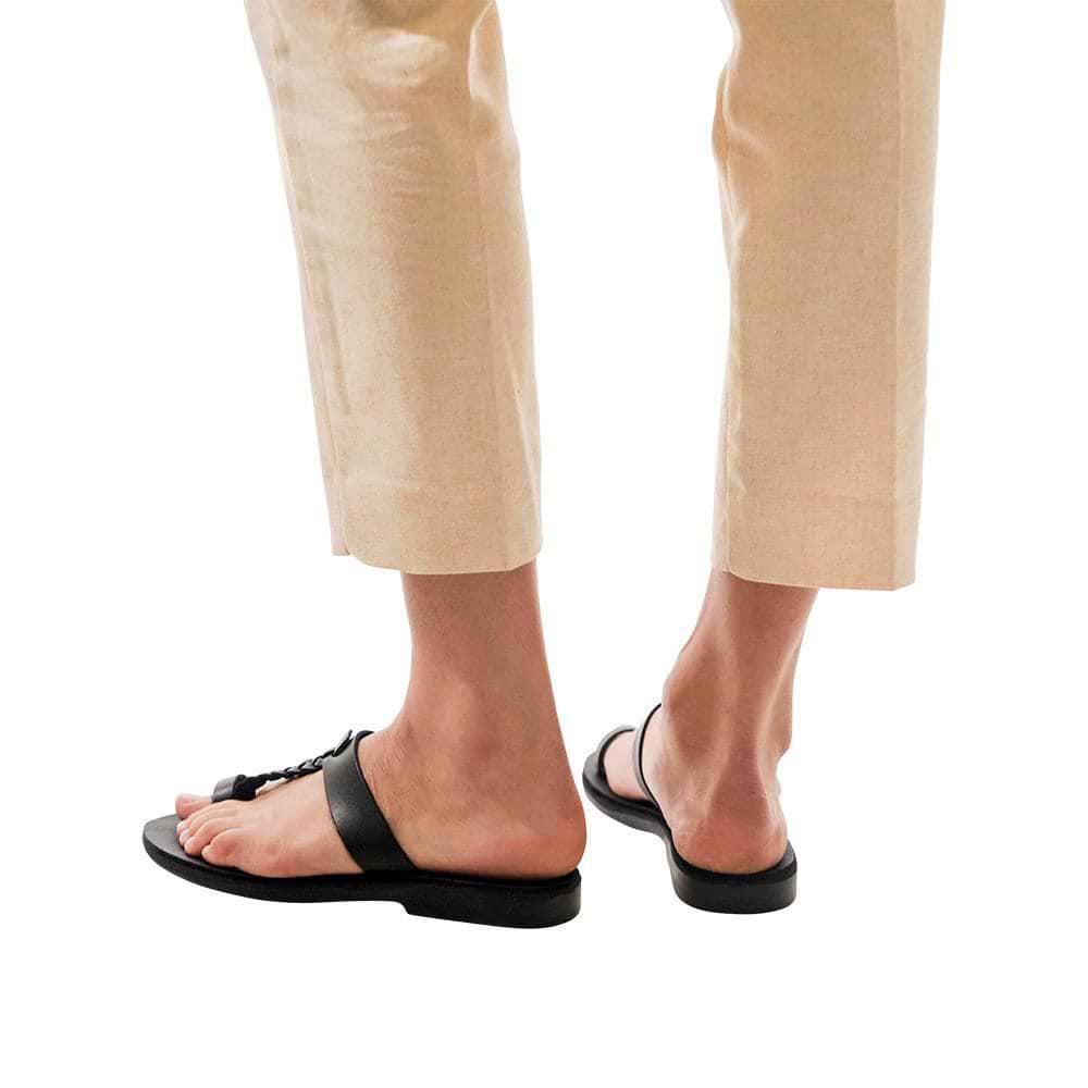 Model wearing Ara black, handmade leather slide sandals with toe loop 