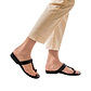 Model wearing Ara black, handmade leather slide sandals with toe loop 