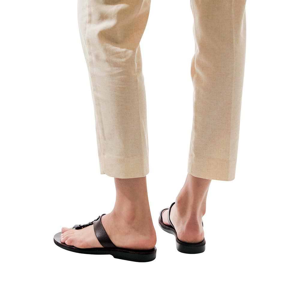 Model wearing Ara brown, handmade leather slide sandals with toe loop