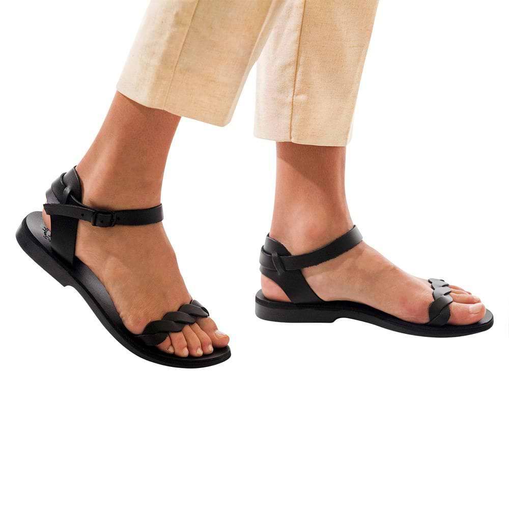 Model wearing Arden black, handmade leather sandals with back strap  