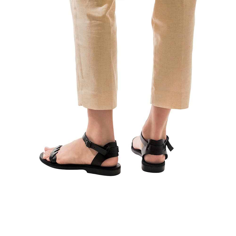 Model wearing Arden black, handmade leather sandals with back strap  