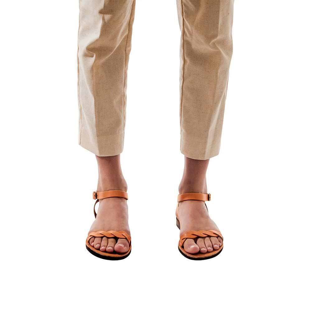 Model wearing Arden tan, handmade leather sandals with back strap  