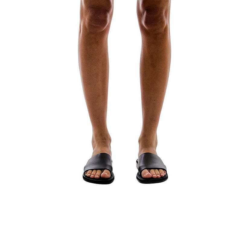 Model wearing Bashan black, handmade leather slide sandals 