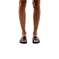 Model wearing Bashan black, handmade leather slide sandals 