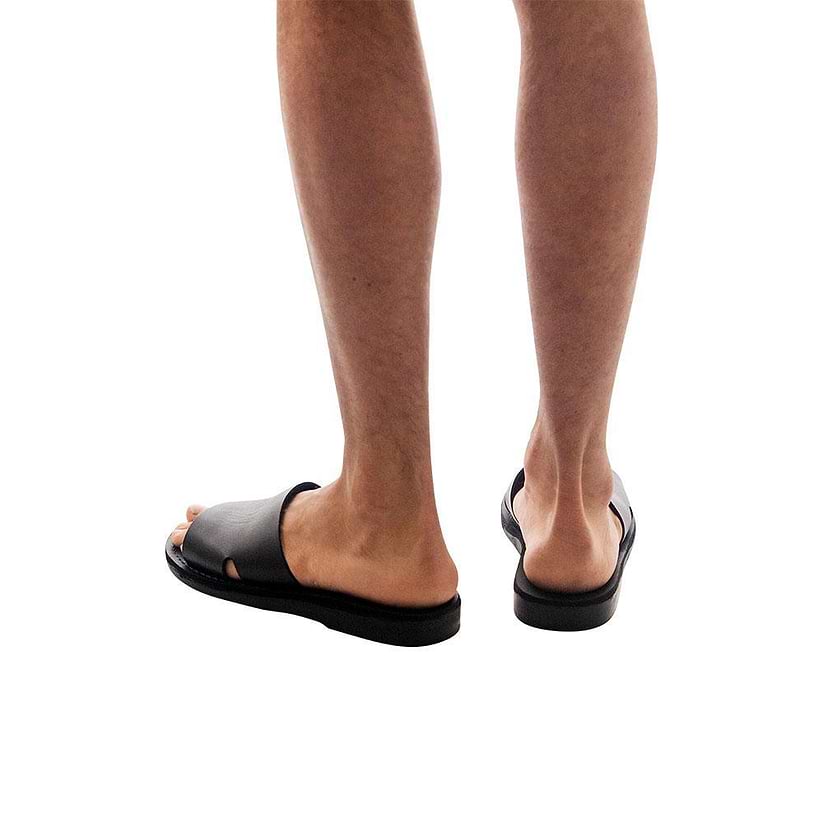Model wearing Bashan black, handmade leather slide sandals 