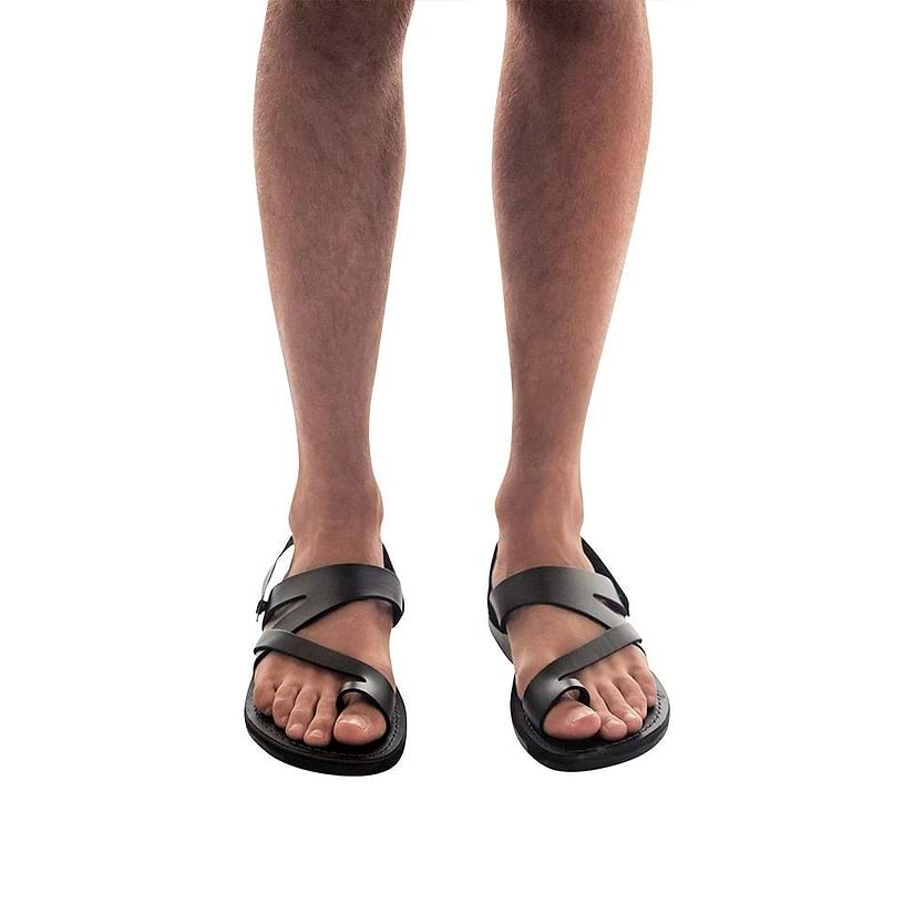 Model wearing Benjamin black, handmade leather sandals with back strap and toe loop 