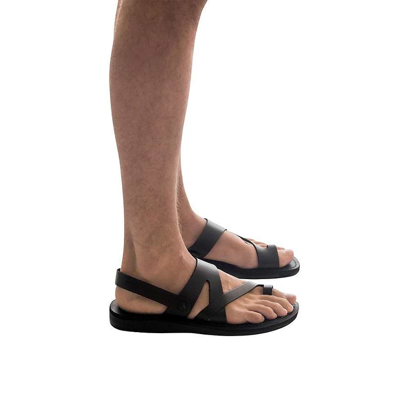 Model wearing Benjamin black, handmade leather sandals with back strap and toe loop 