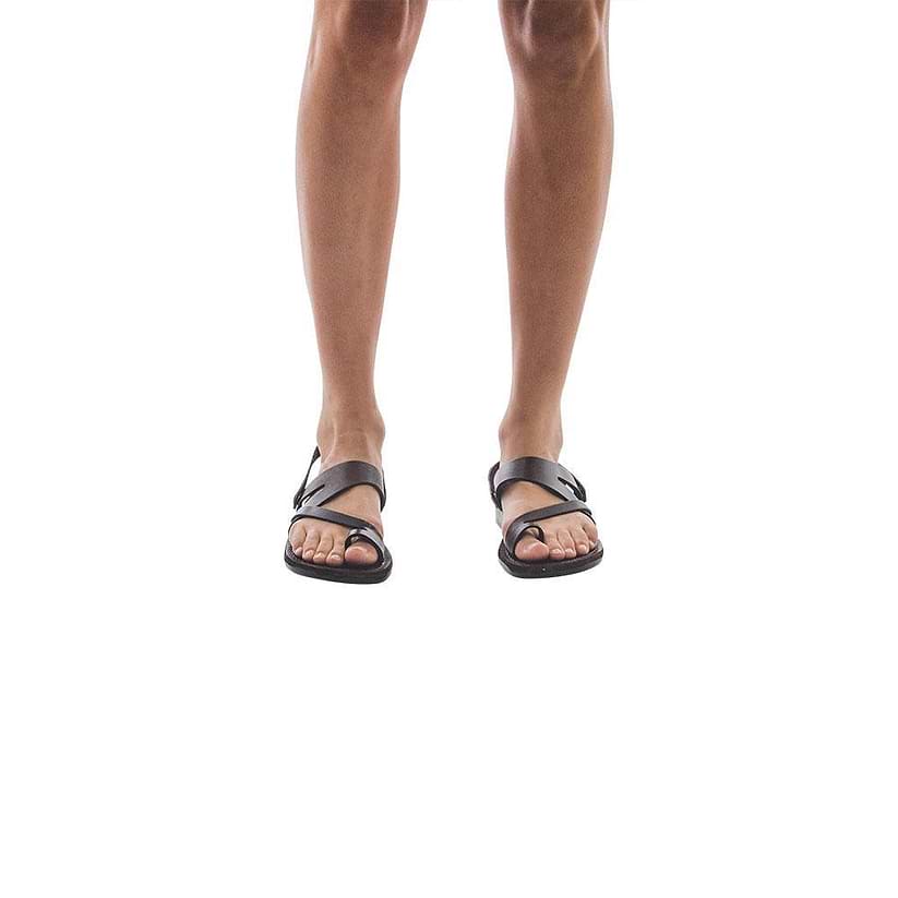 Model  wearing Benjamin black, handmade leather sandals with back strap and toe loop 