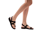 Model wearing Benjamin brown, handmade leather sandals with back strap and toe loop  