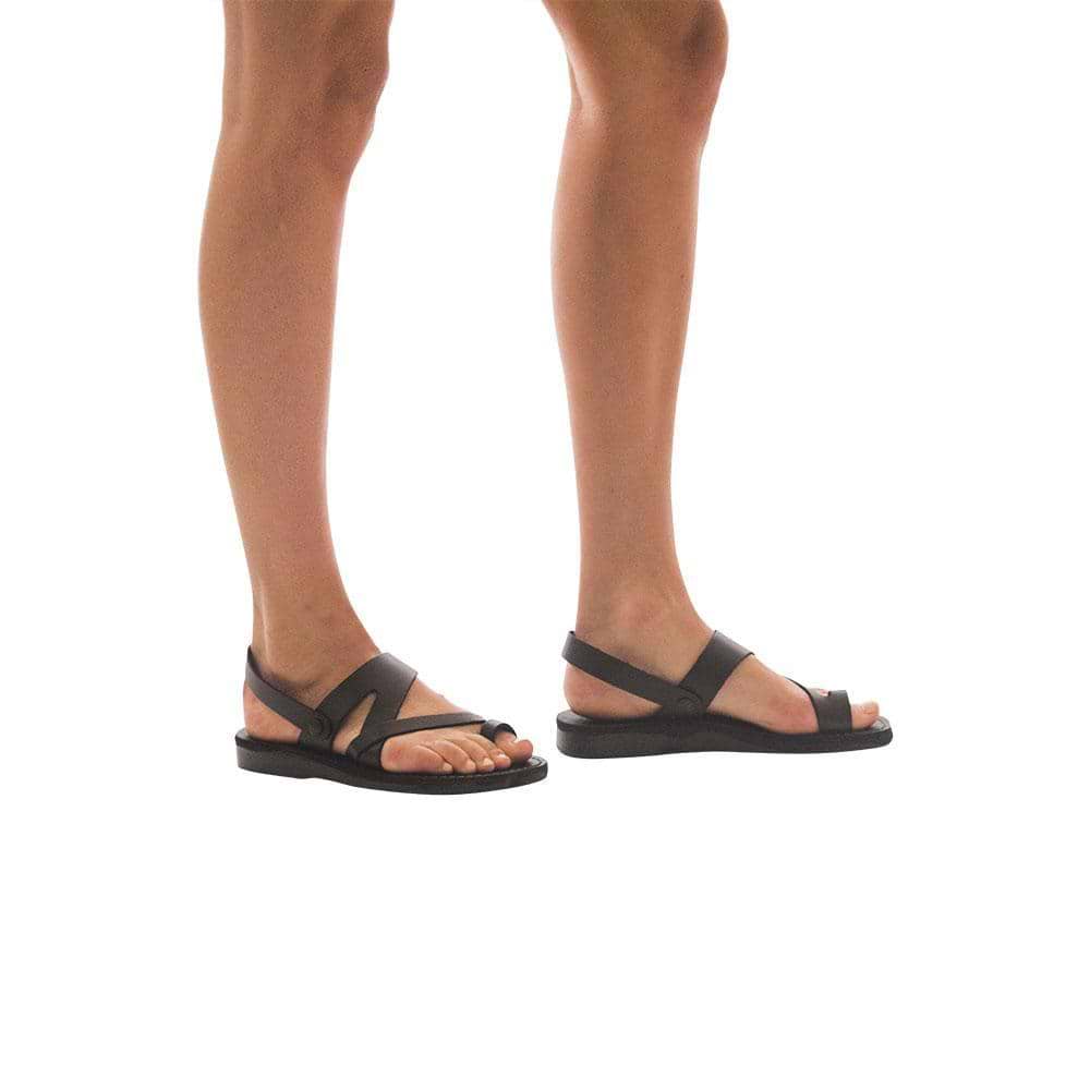 Model wearing Benjamin brown, handmade leather sandals with back strap and toe loop  