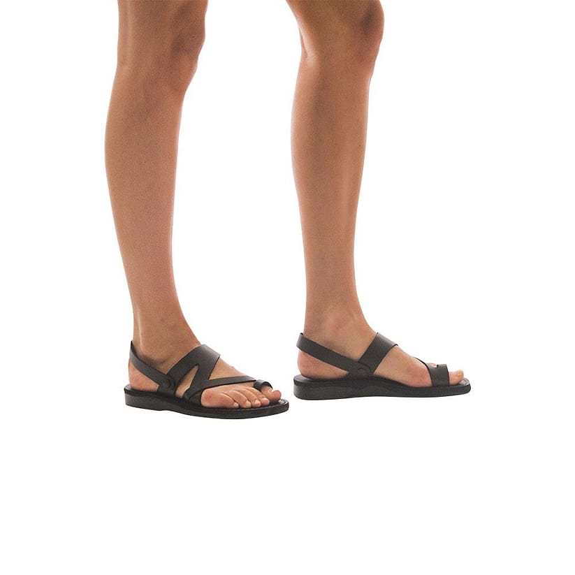 Model wearing Benjamin brown, handmade leather sandals with back strap and toe loop  