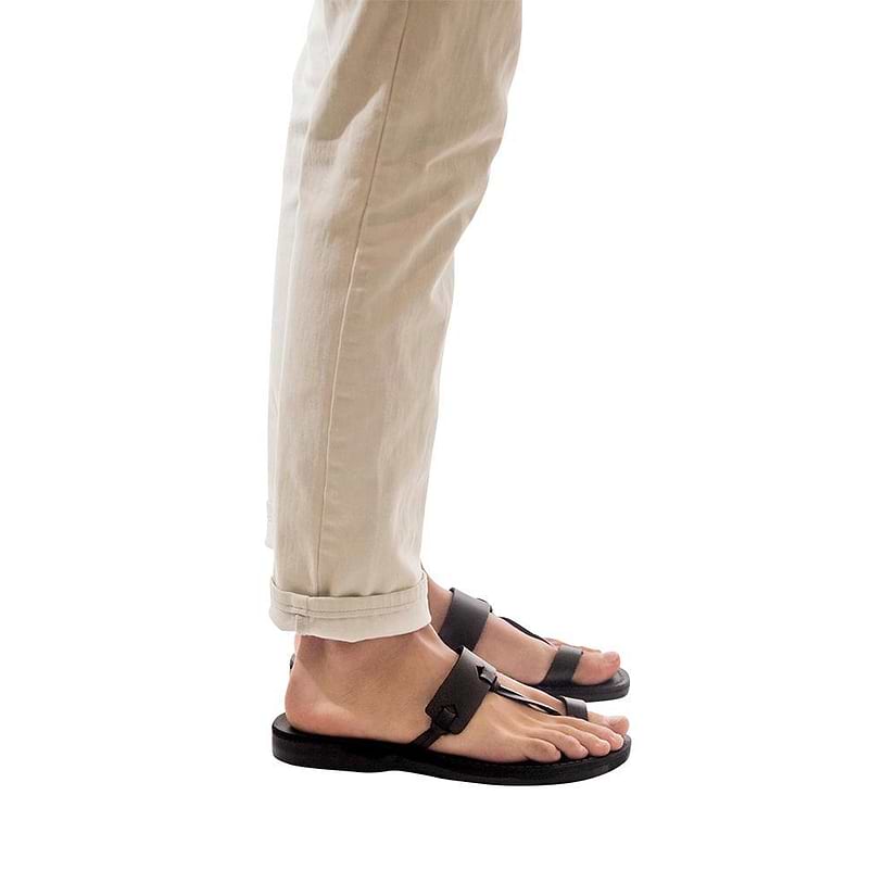 Model wearing David black, handmade leather slide sandals with toe loop