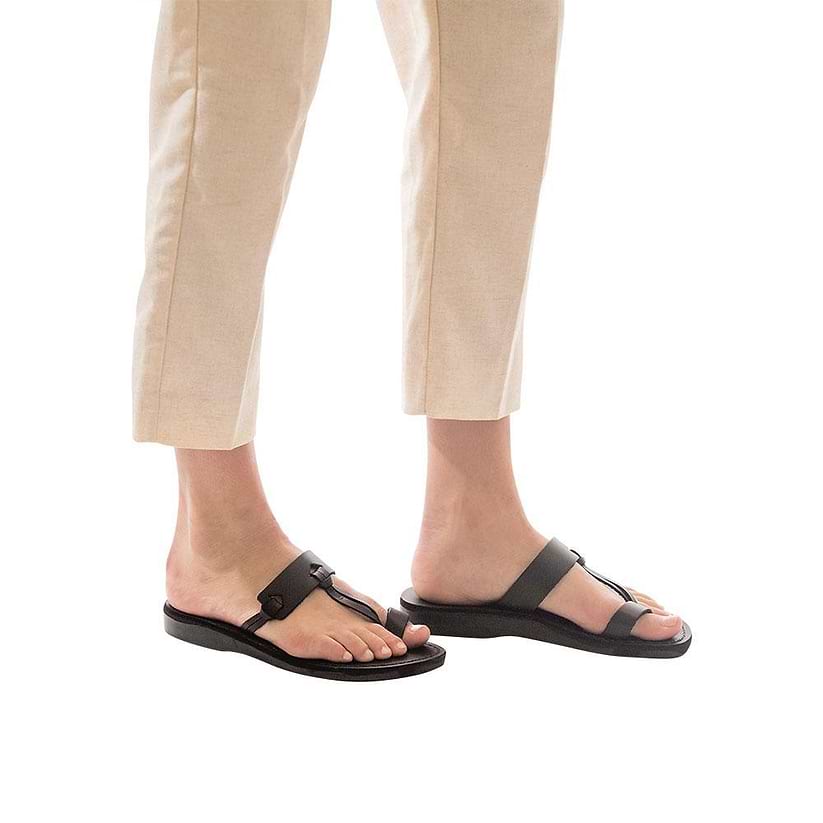 Model wearing David brown, handmade leather slide sandals with toe loop 