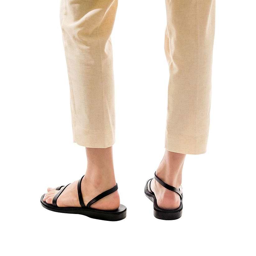 Model wearing Ella black, handmade leather sandals with back strap and toe loop  