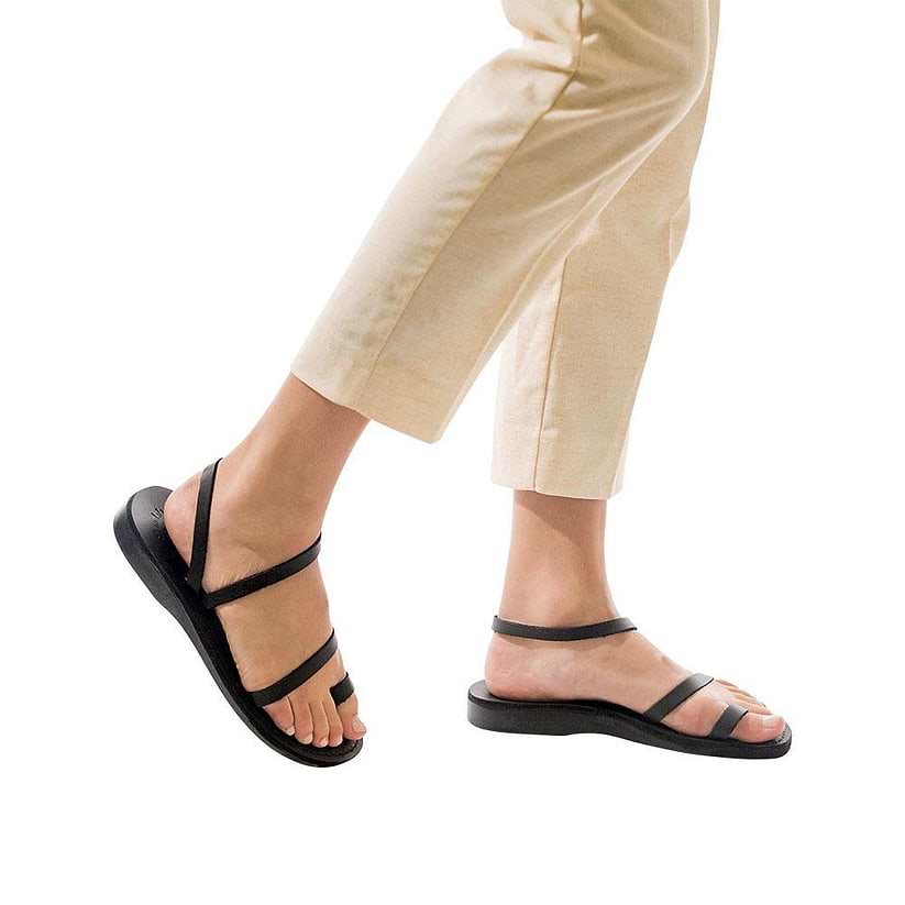 Model wearing Ella black, handmade leather sandals with back strap and toe loop  