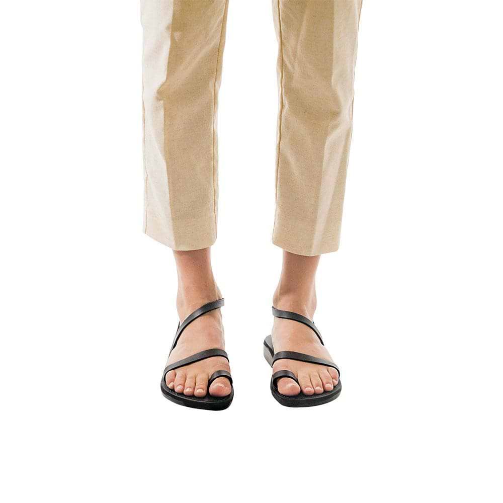 Model wearing Ella black, handmade leather sandals with back strap and toe loop  