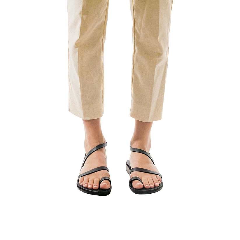 Model wearing Ella black, handmade leather sandals with back strap and toe loop  