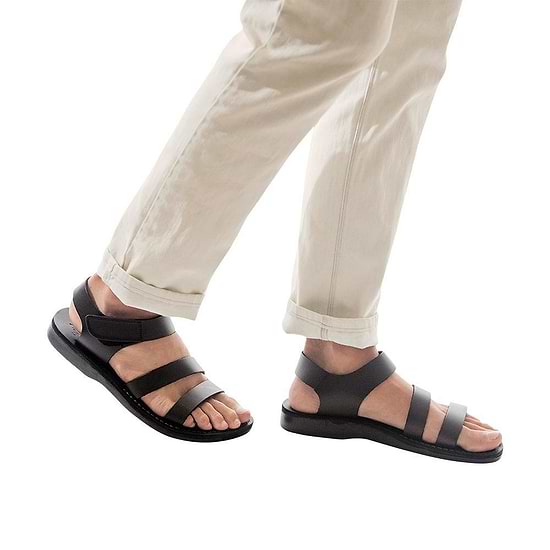 Model wearing Jared black, handmade leather sandals with back strap and toe loop