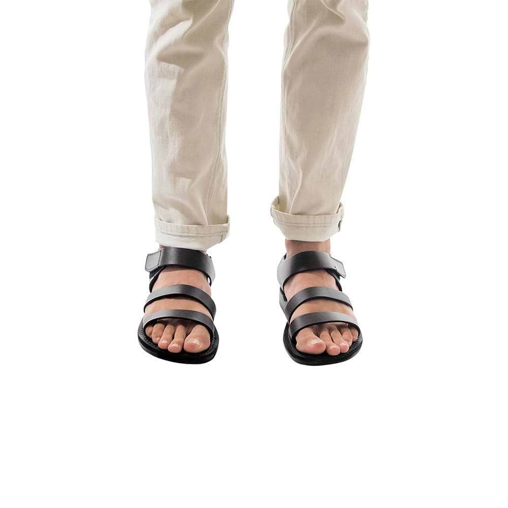 Model wearing Jared black, handmade leather sandals with back strap and toe loop
