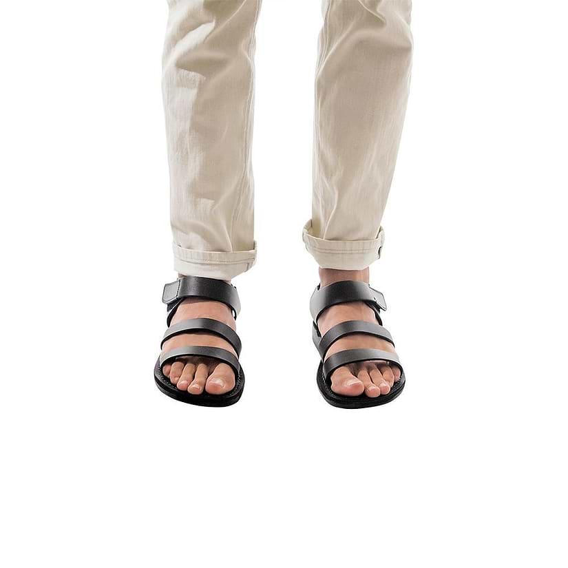 Model wearing Jared black, handmade leather sandals with back strap and toe loop