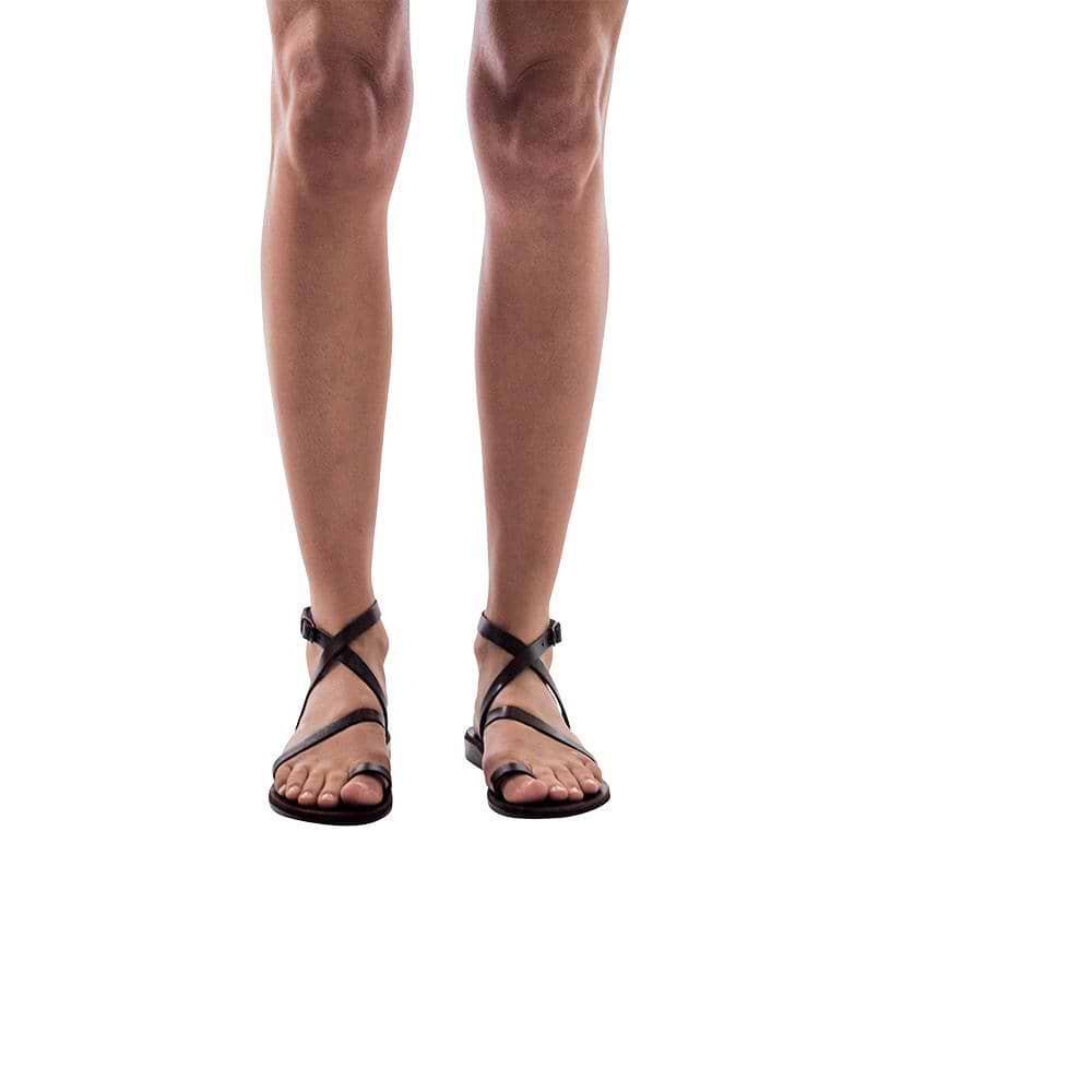 Model wearing Mara black, handmade leather sandals with back strap and toe loop