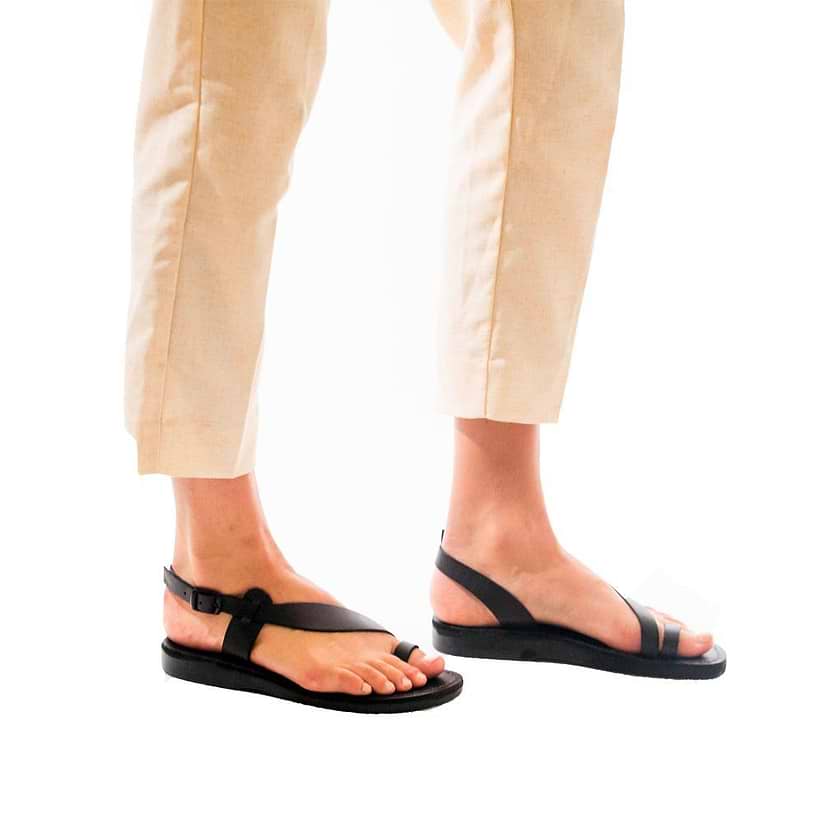 Model wearing Mia black, handmade leather sandals with back strap and toe loop  