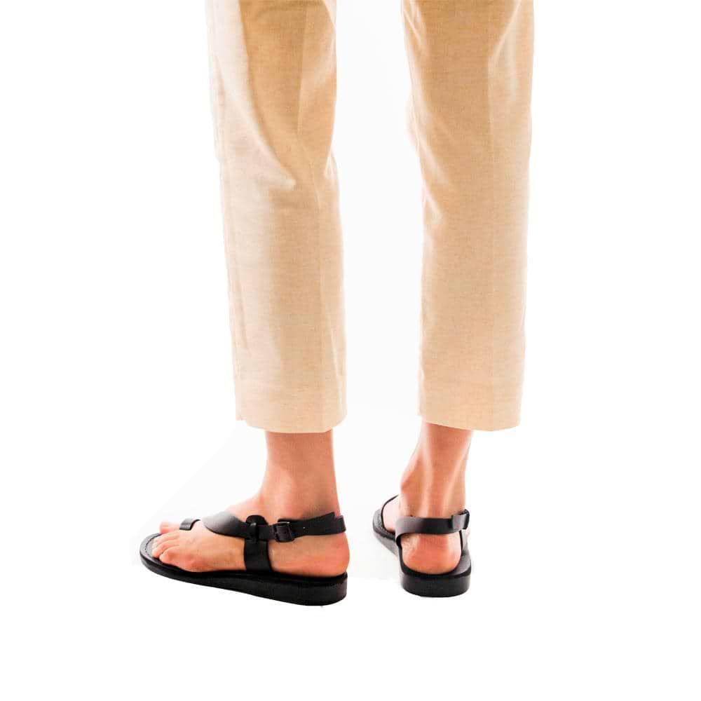 Model wearing Mia black, handmade leather sandals with back strap and toe loop  