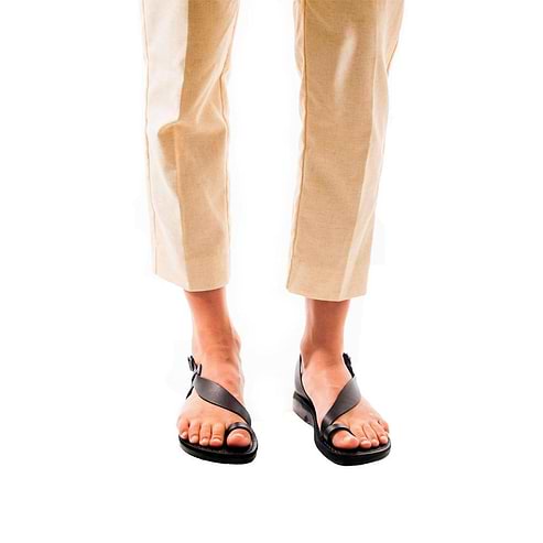 Model wearing Mia black, handmade leather sandals with back strap and toe loop  