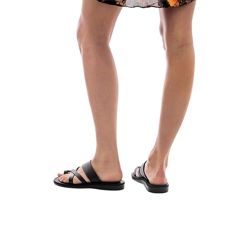Model wearing The Good Shepherd black, handmade leather slide sandals with toe loop