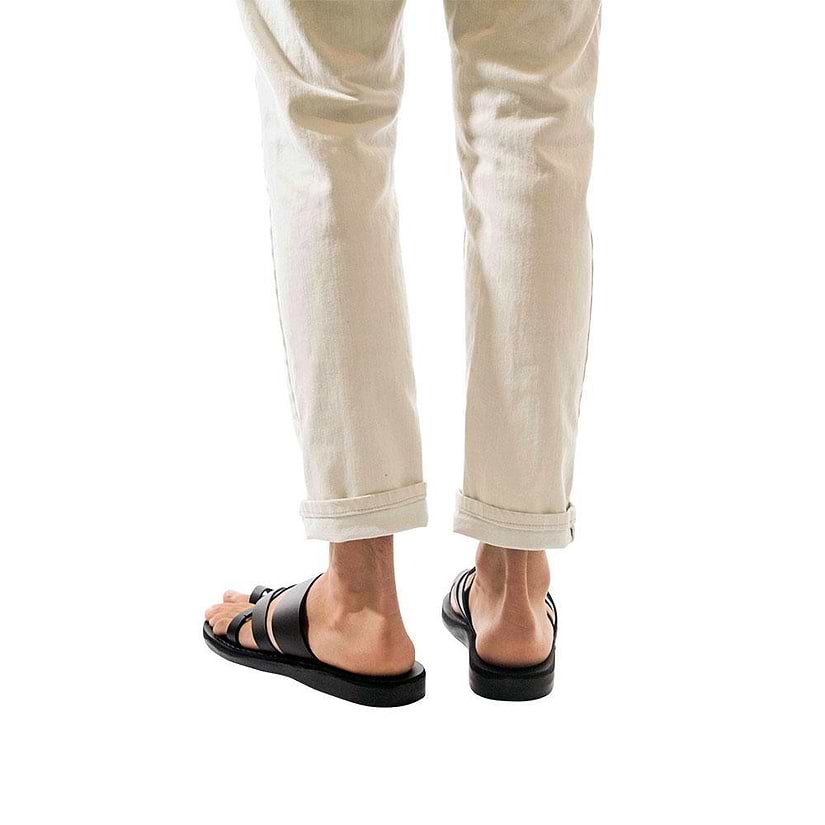 Model wearing The Good Shepherd black, handmade leather slide sandals with toe loop